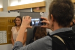 Service Learning Initiative for Community Engagement in Sociology (SLICES) attendees snap photographs of Alyssa Medina.