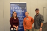 Raegen Pietrucha and Dr. Brian Hedlund pose in front of the Research Forum banner.